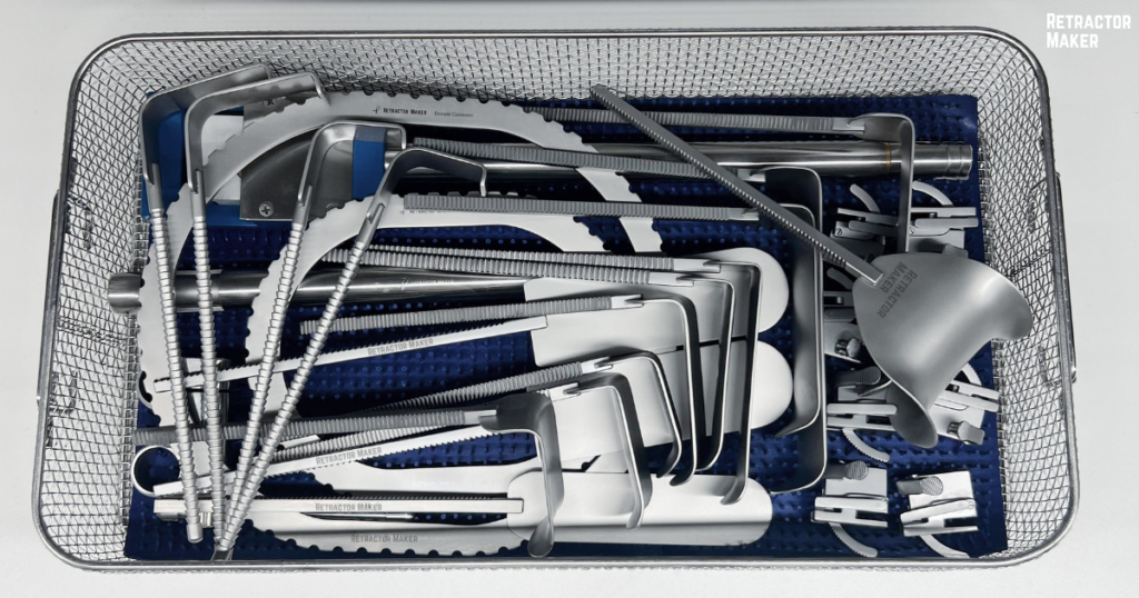 Disassembled Bookwalter Retractor System parts organized inside a perforated autoclave tray